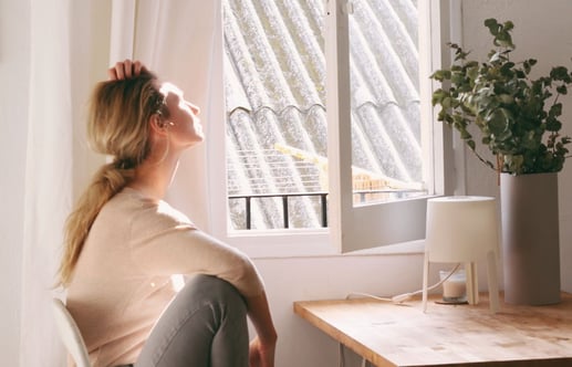 woman-at-table-looking-out-window